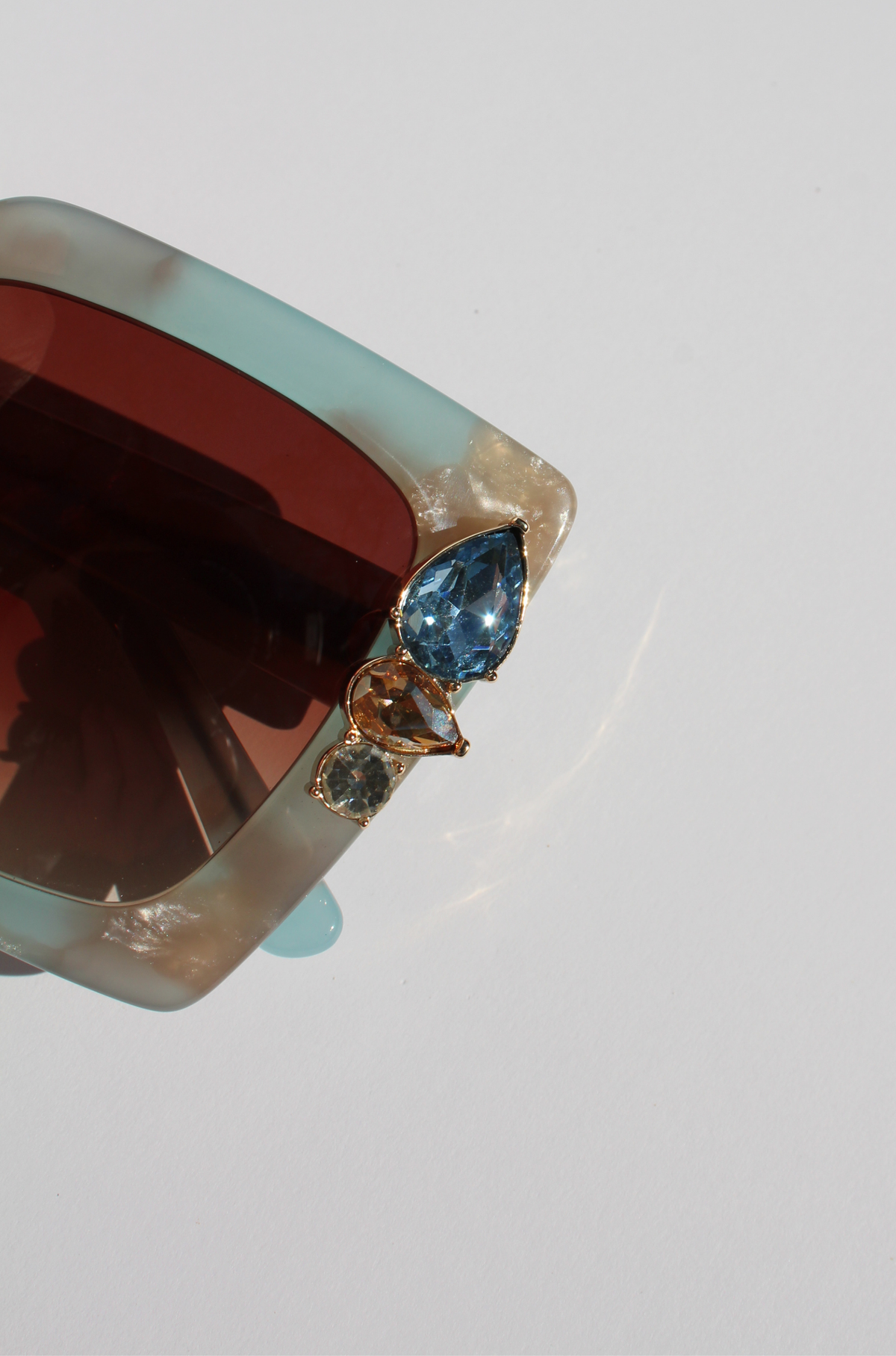 SKYSHINE ~ Oversized square sunglasses in a pale blue and shimmering apricot acetate with statement crystal embellishments