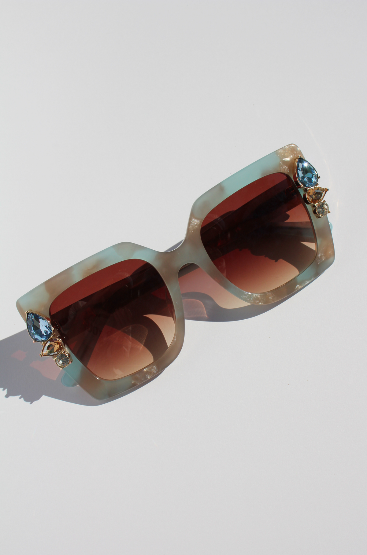 SKYSHINE ~ Oversized square sunglasses in a pale blue and shimmering apricot acetate with statement crystal embellishments