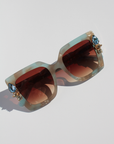 SKYSHINE ~ Oversized square sunglasses in a pale blue and shimmering apricot acetate with statement crystal embellishments