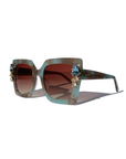 SKYSHINE ~ Oversized square sunglasses in a pale blue and shimmering apricot acetate with statement crystal embellishments