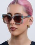 SKYSHINE ~ Oversized square sunglasses in a pale blue and shimmering apricot acetate with statement crystal embellishments
