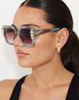 SKYSHINE ~ Oversized square sunglasses in a pale blue and shimmering apricot acetate with statement crystal embellishments