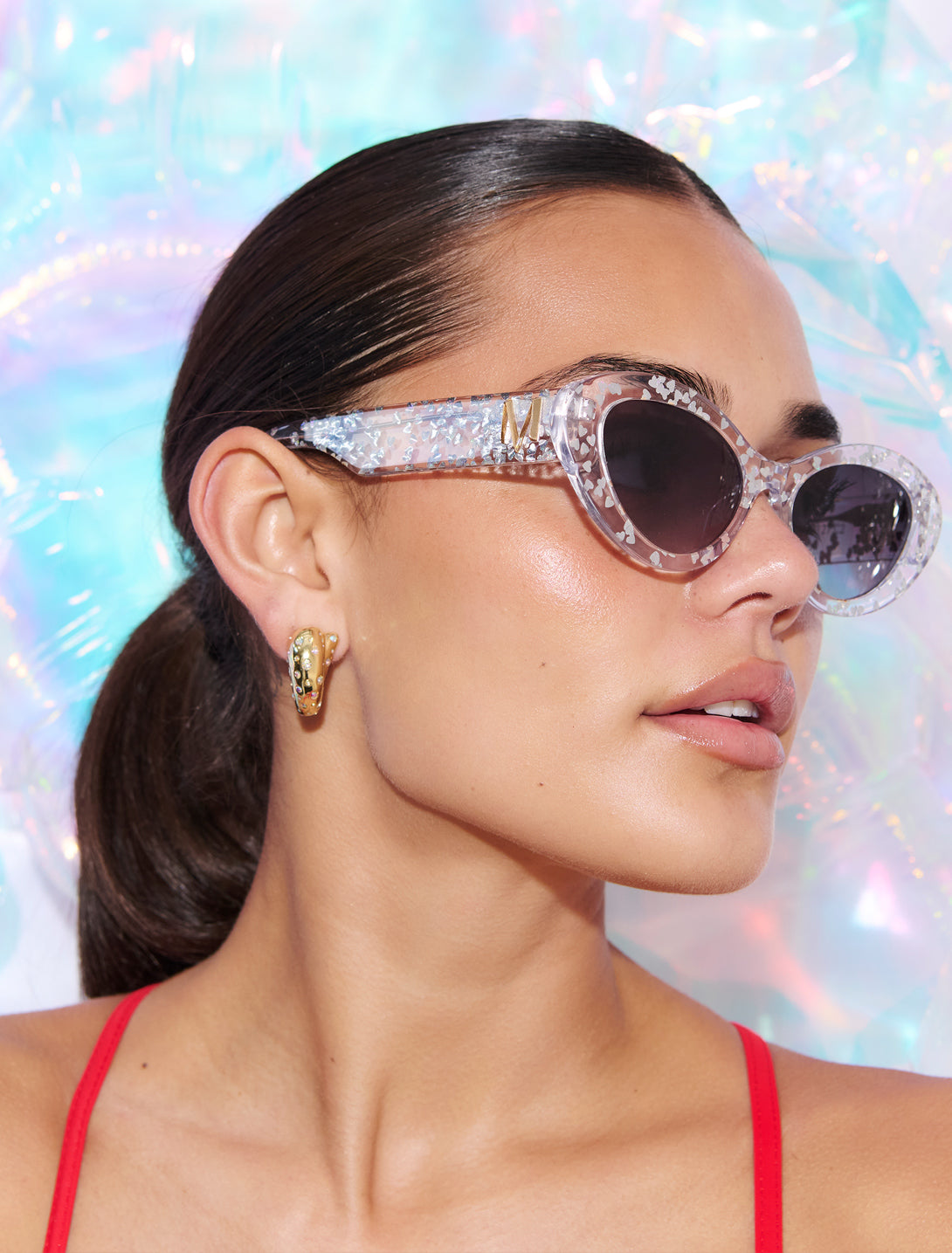 SILVELLE ~ Oval shaped sunglasses in clear acetate sprinkled with iridescent silver love heart sequins