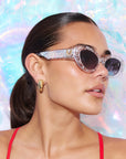 SILVELLE ~ Oval shaped sunglasses in clear acetate sprinkled with iridescent silver love heart sequins