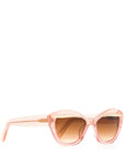 Side view of an elegant pink glittery cat eye framed sunglasses with a gold flick up top of the lenses and a brown gradient lense. Set against a white backdrop. The brand name MAUDE is featured in gold on the arm on the frame