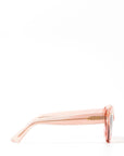 Side view of an elegant pink glittery cat eye framed sunglasses. Set against a white backdrop. The brand name MAUDE is featured in gold, subtly on the arm on the frame