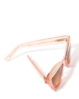 top view of an elegant pink glittery cat eye framed sunglasses with a gold flick featured on top of the lenses. Set against a white backdrop. The brand name MAUDE is featured in gold, subtly on the arm on the frame