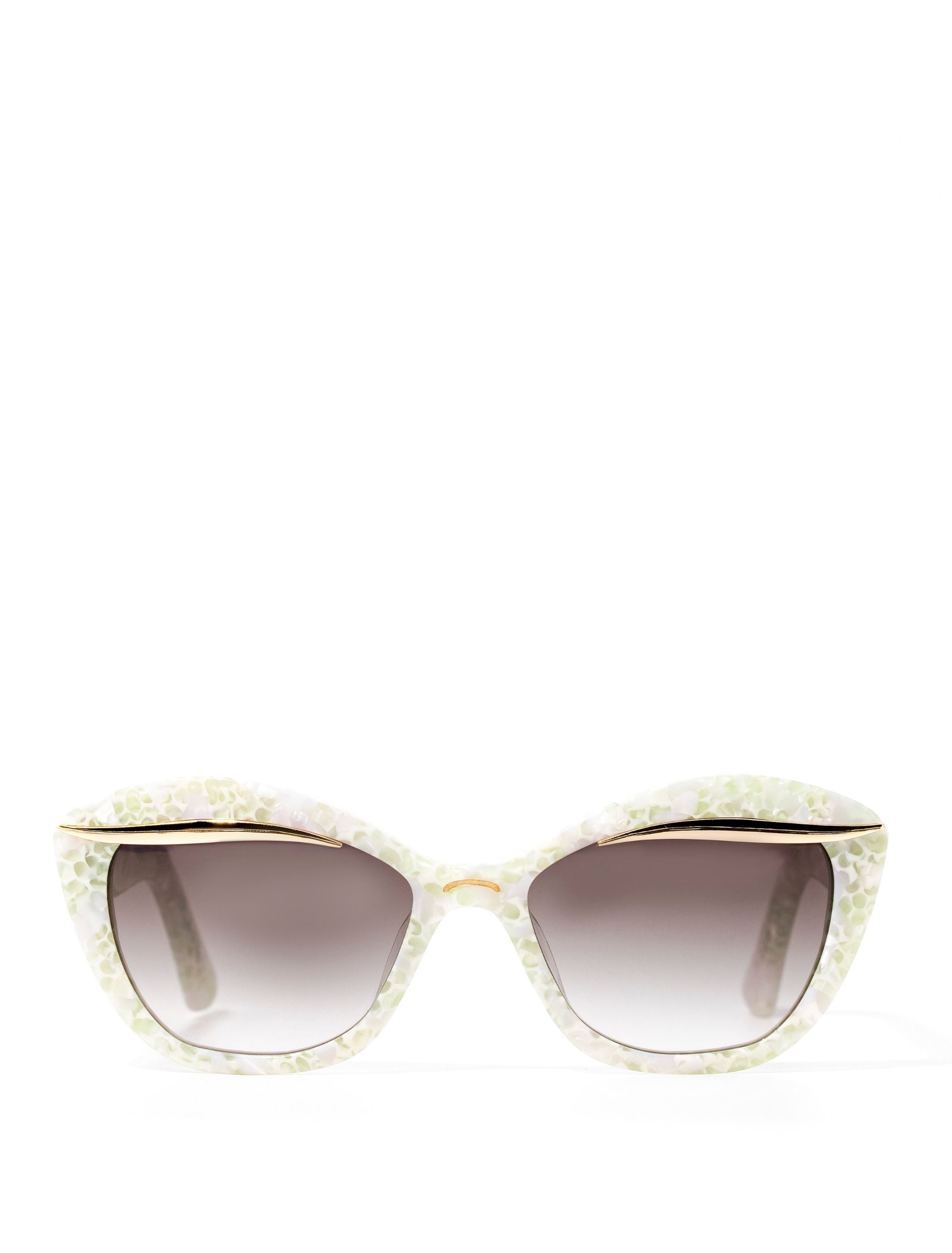 Front view of a stylish pair of sunglasses adorned with a gold flick along the upper lense and a subtle white pearl frame, set against a white backdrop. Featuring a dark grey gradient lense 