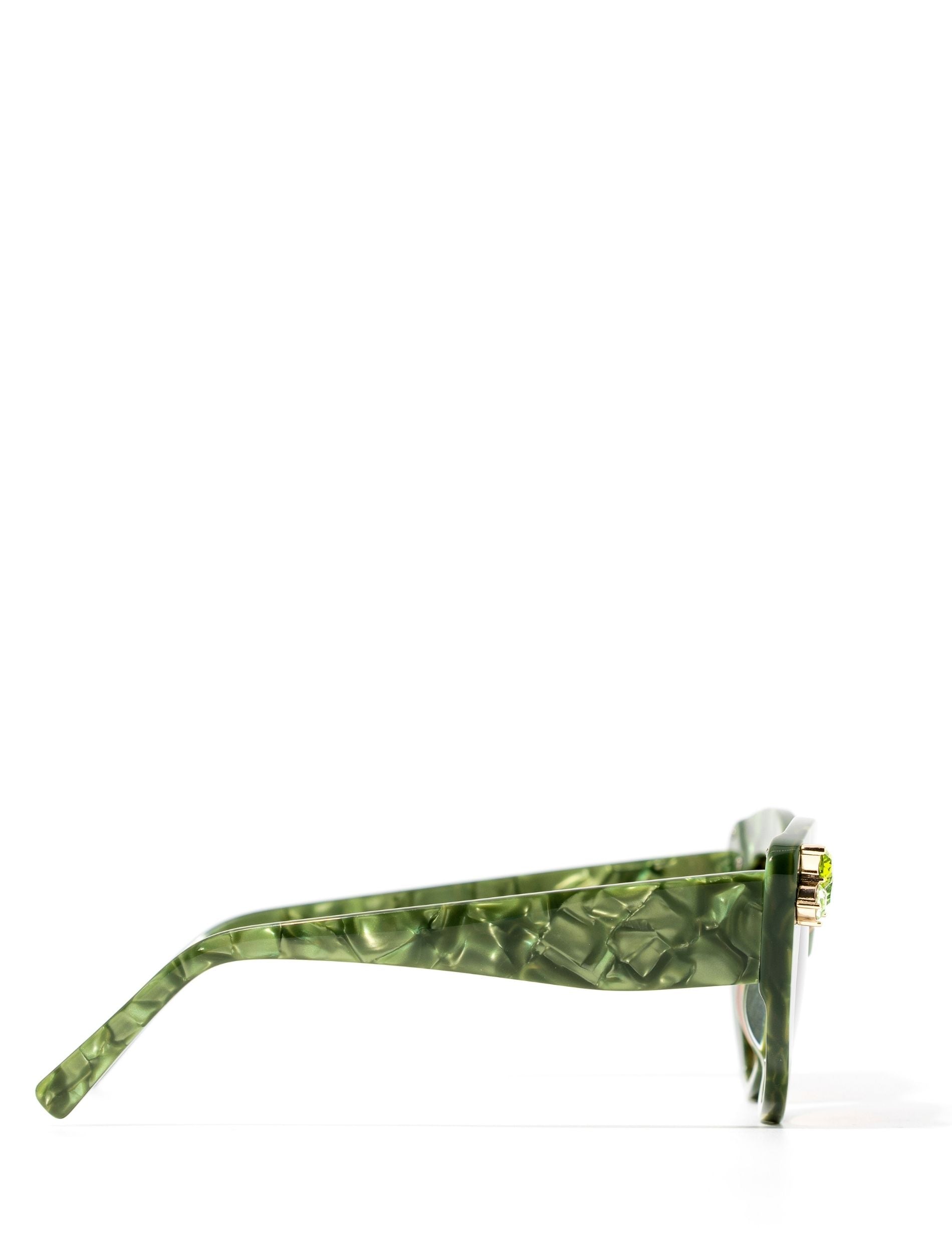 Front view of stunning cat eye sunglasses crafted with a green pearlescent look,  featuring gemstone embellishments on the upper corners of the frame. Set against a white backdrop