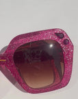 Rosinite ~ Oversized pink oval sunglasses in glitter acetate with fuchsia crystal detailing