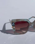 SKYSHINE ~ Oversized square sunglasses in a pale blue and shimmering apricot acetate with statement crystal embellishments