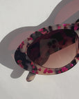 JEWELISSA ~ Oval shaped sunglasses in tortoiseshell acetate sprinkled with vibrant pink hearts