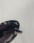 ONYX NOIR ~ Oval shaped sunglasses in marbled black and blush with shimmering turquoise acetate